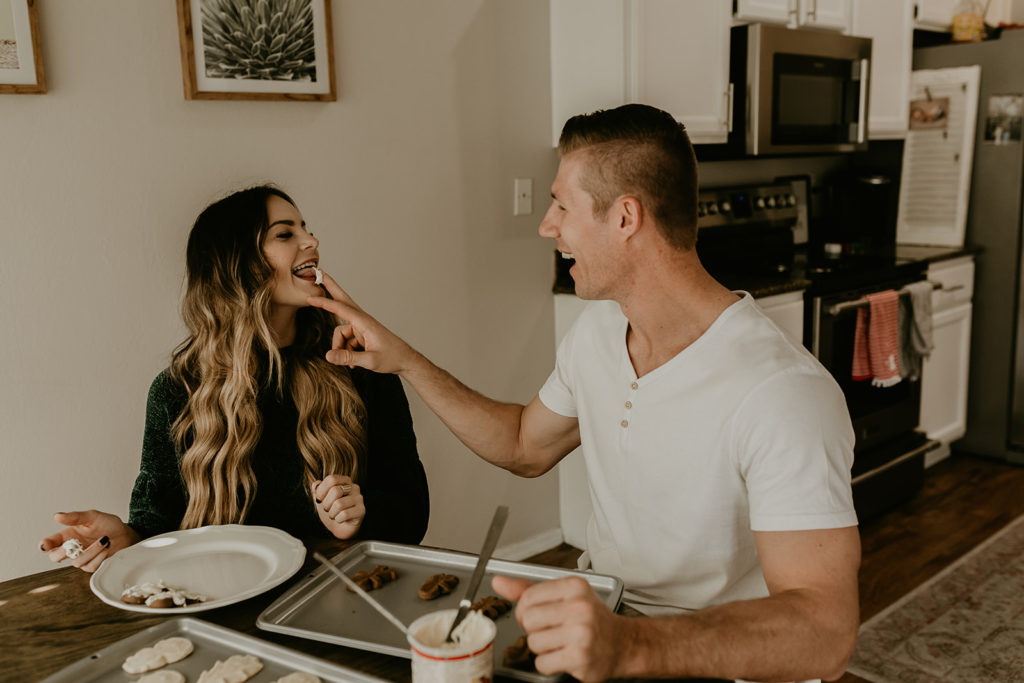 couple baking christmas cookies together, holiday photoshoot ideas